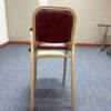 Rear view of hotel baby dining chair with golden frame and maroon upholstered backrest