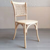 Angled view of loop-back dining chair with rope-woven backrest and natural rattan seat on beech wood frame
