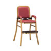 Red upholstered hotel baby high chair with safety belt, footrest, and golden frame on white background