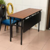 IBM training table with folding steel modesty panel and wood laminate top, displayed with blue and gold banquet chairs