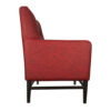 Side view of red fabric hotel lounge chair with black aluminum legs