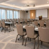 Commercial conference room featuring Bresaro Flax-Back Banquet Chairs with waterproof upholstered seating arranged for corporate training and meeting events.
