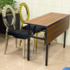 Side angle view of IBM training table with foldable MDF modesty panel and metal frame, placed beside modern event chairs