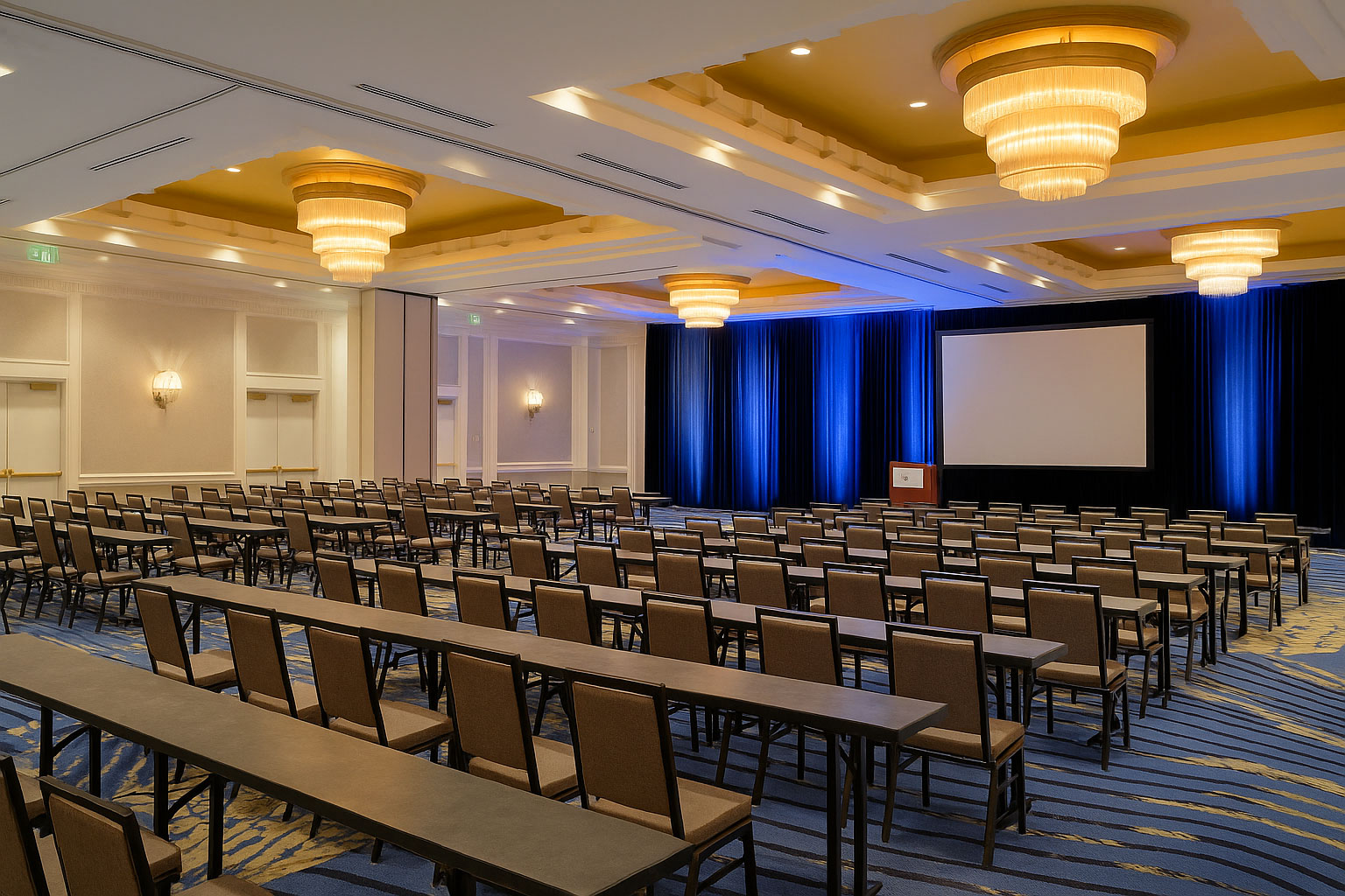 Modern hotel ballroom with rows of banquet chairs and training tables, set for a conference or seminar at Marriott Seattle Waterfront
