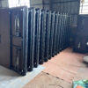 Foldable training tables stacked vertically in a workshop, showing compact storage with power modules and underside frame details