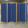 Blue acoustic banquet hall partition with golden frame edges and caster wheels, movable folding divider for hotels, restaurants, and event halls.