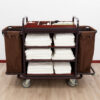 Professional hotel housekeeping cart with shelves, side bags, and wheels – front view