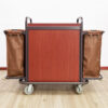 Rear view of a hotel housekeeping trolley with wooden back panel and dual side bags