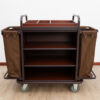Side view of a hotel housekeeping trolley with storage shelves and fabric side bags on wheels