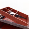 Close-up of top organizer tray on hotel housekeeping cart with compartments for amenities