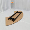 Upturned serpentine banquet table displaying folding metal legs and cross-brace structure