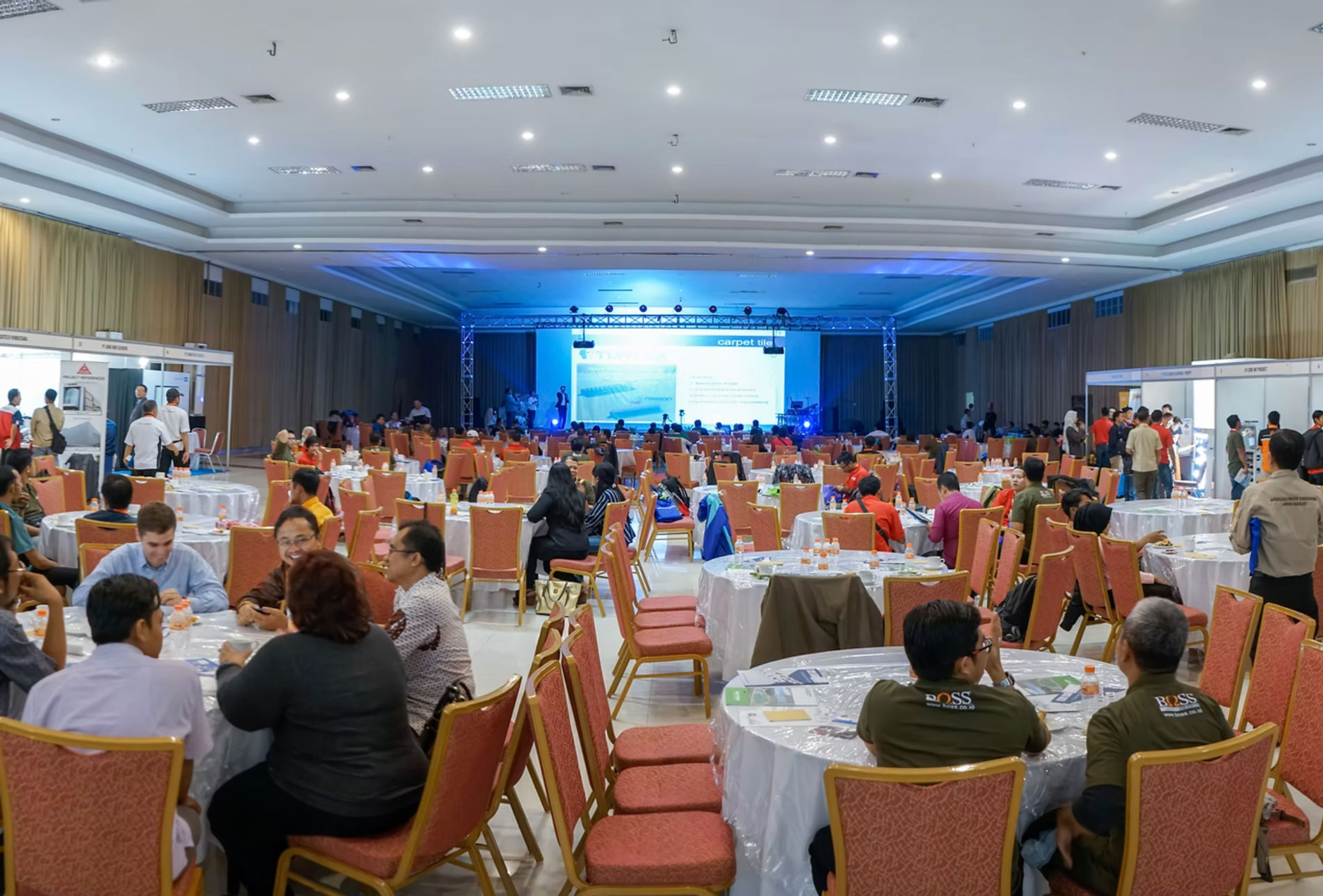 Stackable banquet chairs in the Sheraton Langkawi conference room with stage and projector setup