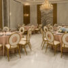 Rhythm Back Banquet Chairs in Luxury Wedding Banquet Hall with Gold Aluminum Frames and Ivory Cushions