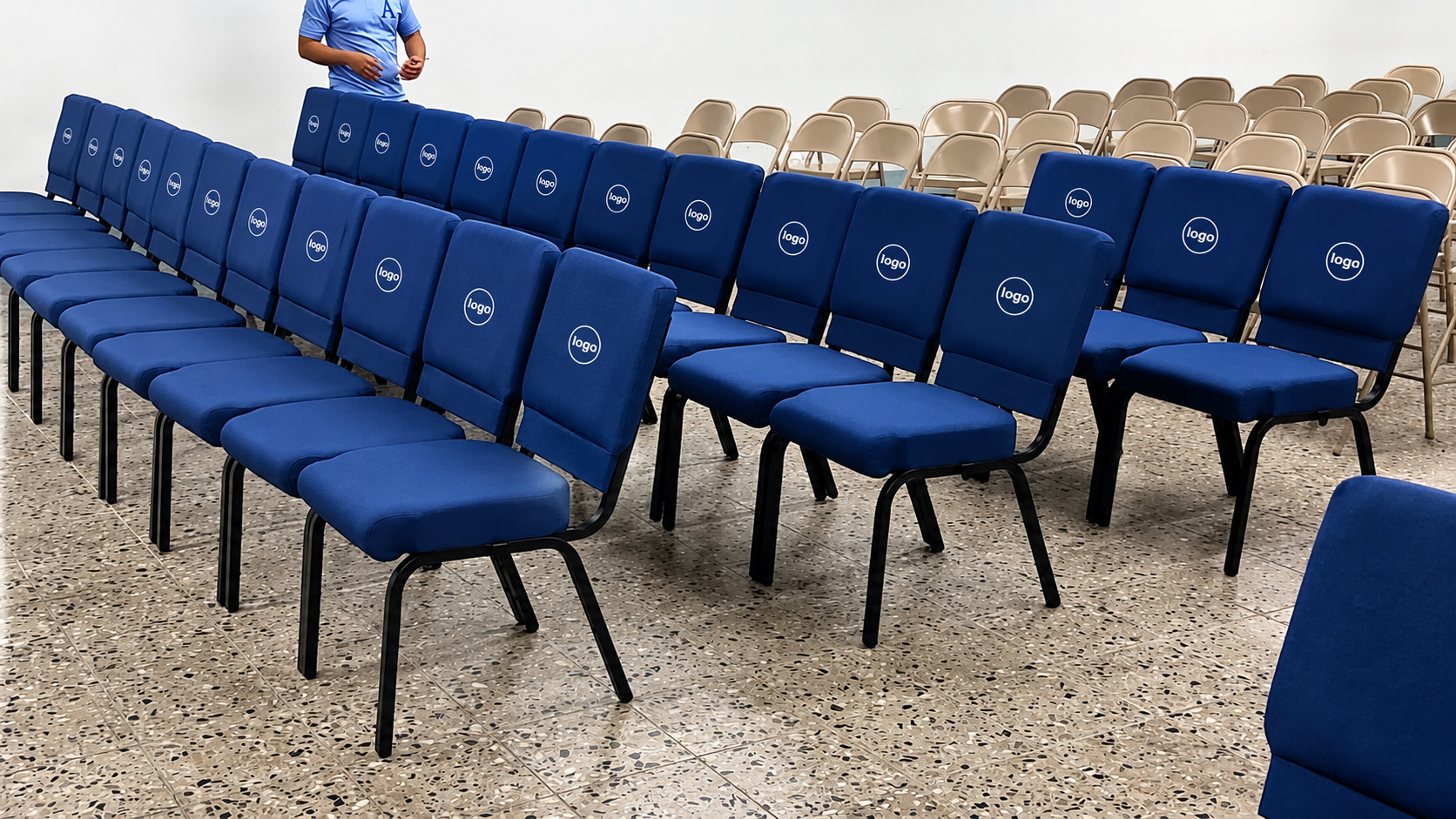 Blue upholstered church chairs with custom logo branding arranged in worship hall installation setup