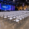 Folding plastic banquet chairs arranged in large conference hall event setup commercial seating bulk application