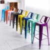 Industrial low-back Tolix stool collection in multiple powder-coated colors including blue, orange, pink, gunmetal, black, yellow, navy blue, mint green and purple for commercial restaurant and cafe seating.