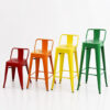 Industrial low-back Tolix stool collection showing 45cm, 60cm, 65cm and 76cm seat height options in colorful powder-coated metal finishes for restaurant, cafe and hotel seating.
