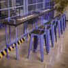 Industrial pipe bar table set with purple metal frame, black wood tabletop and matching Tolix bar stools for cafés, restaurants and commercial interiors.