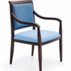 Heritage Aluminum Arm Dining Chair with dark wood grain frame and blue upholstered seat and back, one of the available custom color options for senior living and healthcare seating.