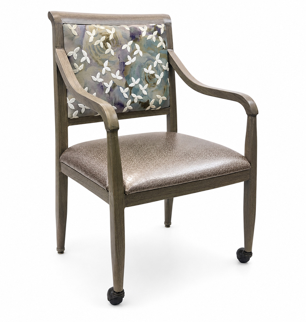 Heritage Aluminum Arm Dining Chair with light oak wood grain finish, floral upholstered back, taupe seat cushion, and front leg casters, shown as a custom color option for senior living and healthcare seating.