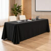 Black rectangular polyester tablecloth with floor-length drape on a conference table in a modern hotel meeting room